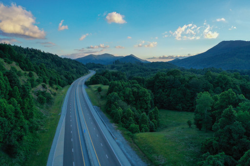 Empty road winding in rolling green hills  traveling off into the distance in Tennessee