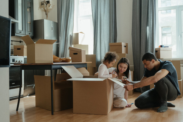 Family moving and packing belongings into moving boxes as they prepare to relocate to Tennessee